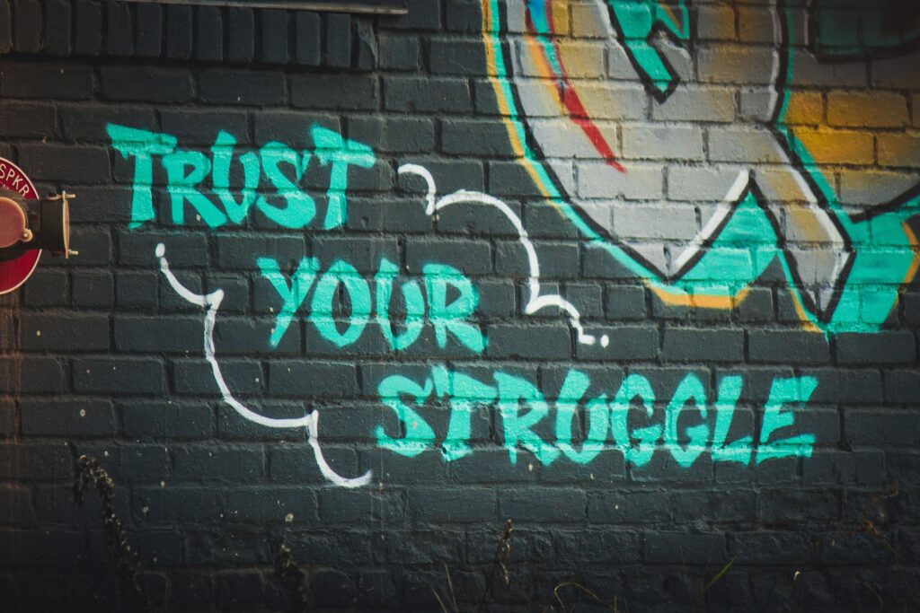Embrace your struggle quote saying trust your struggle on a motivational background.